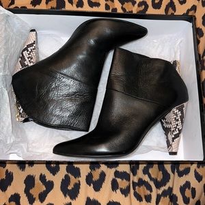 Black leather dolce vita snakeskin heel with a point toe
